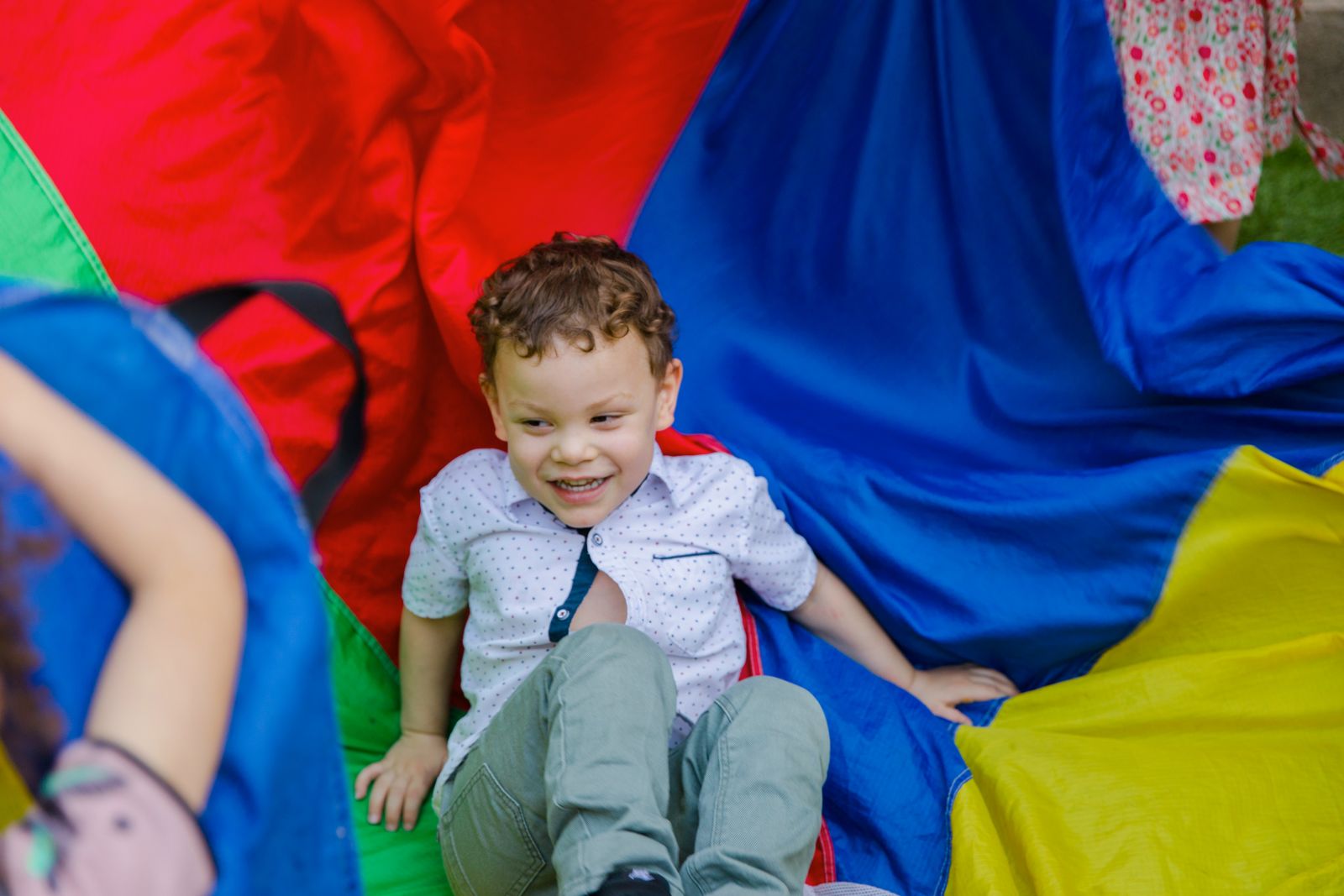 Bright play scarves draped across a sunny playroom floor